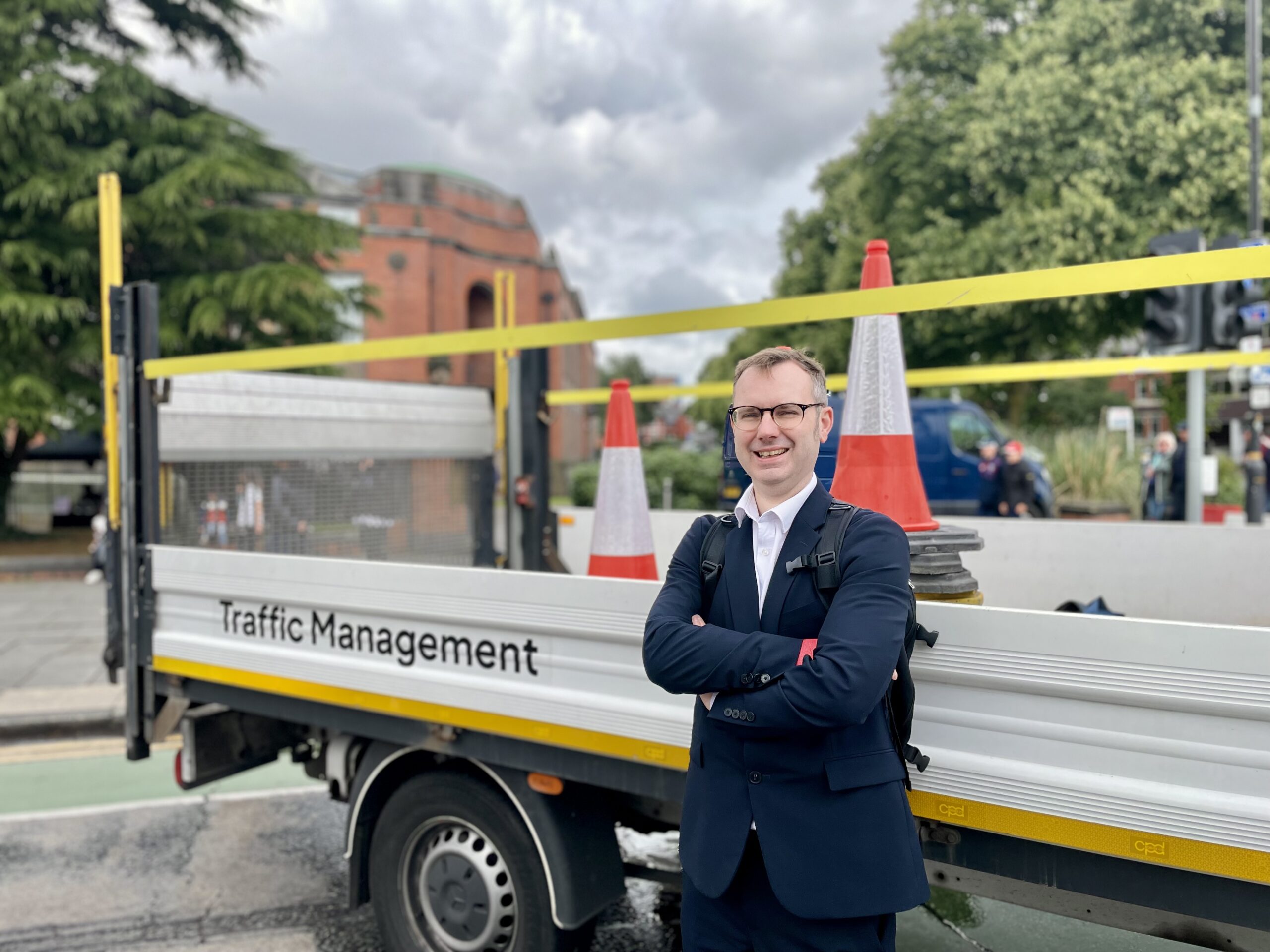 Tom stood with some cones.